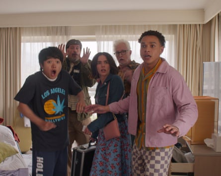 Five astonished people of various ages standing in a living room