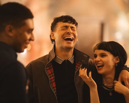 A man and woman laughing together.