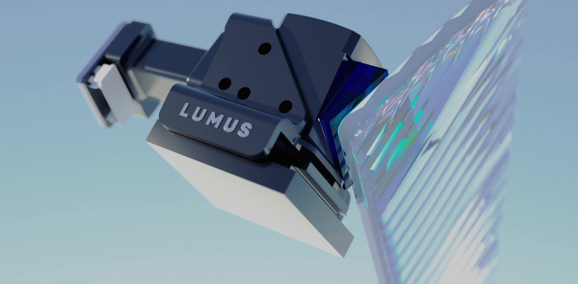 Render of a dark navy Lumus optical engine housing, with LUMUS embossed on its side, coupling light into a transparent waveguide plate whose internal reflective facets show as blue and green stripes