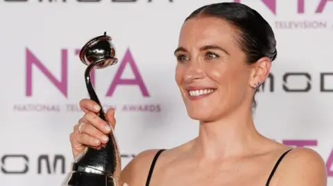 PA Media Vicky McClure holding an award