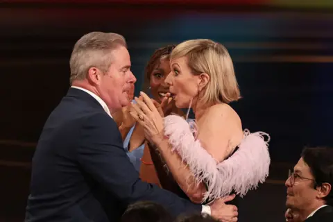 Getty Images Emmy winner Allison Janney, right, is shocked and is embraced during the ceremony before her acceptance speech