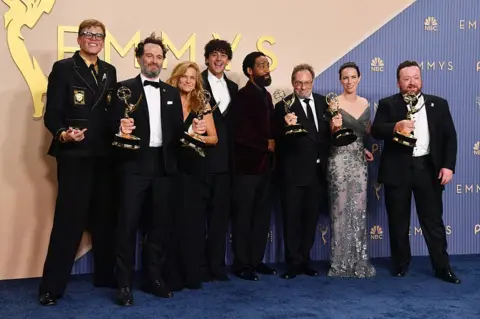Getty Images Jeff Hiller, Matthew Rhys, Dale Dickey, Kingston Rumi Southwick, Kevin Carroll, Stephen Root, Kate O'Flynn and Neil Casey of Widow's Bay pose with their Emmy Awards