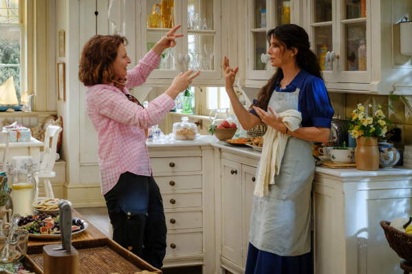 This image released by Warner Bros. Pictures shows director Susanne Bier, left, with Sandra Bullock, on the set of "Practical Magic 2." (Warner Bros. Pictures via AP)