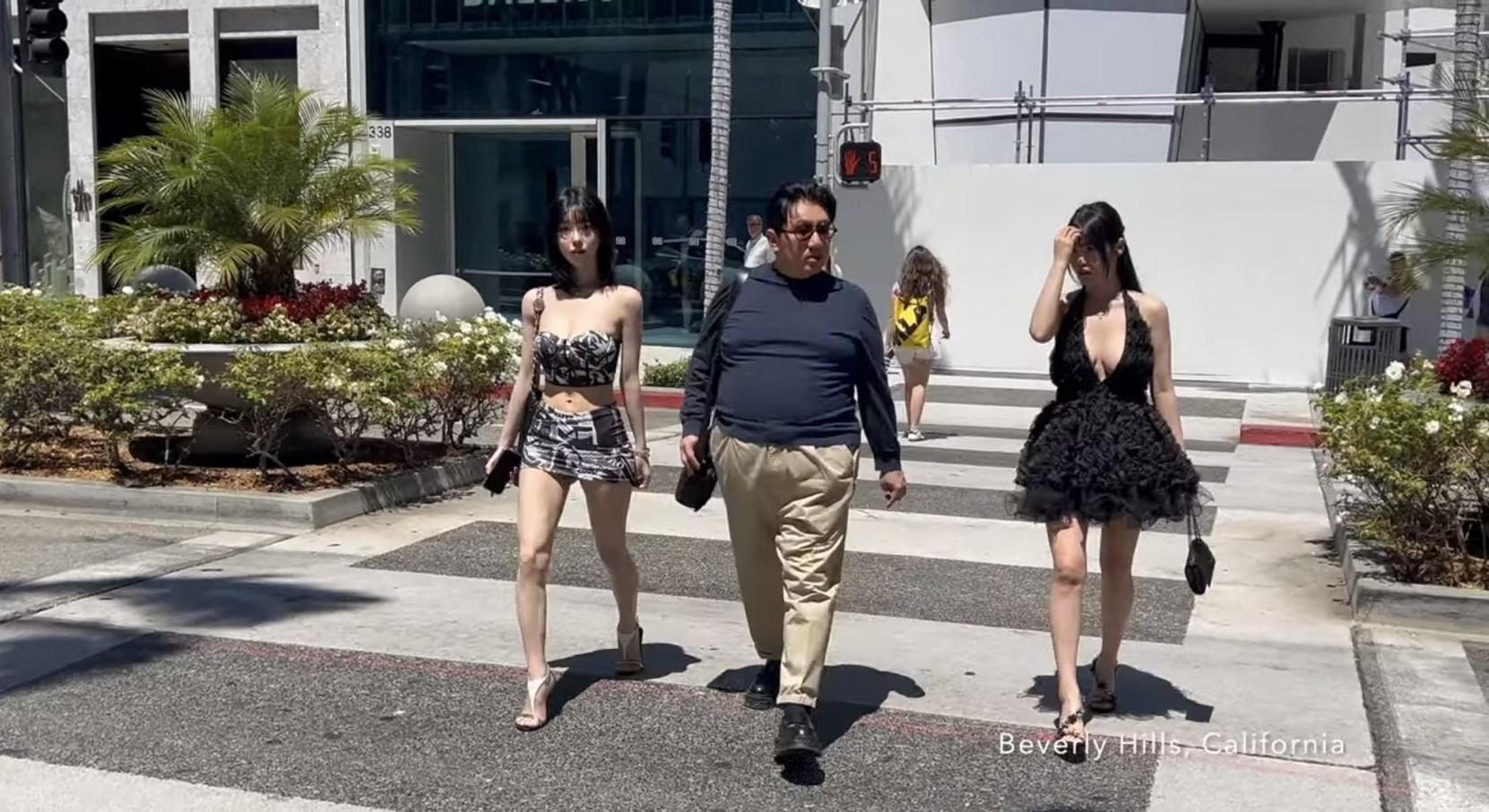 HYBE Chairman Bang Si-hyuk, center, is seen walking along livestreamer Seyeon, left, and her older sister in Beverly Hills, Calif., in August 2024. Captured from YouTube