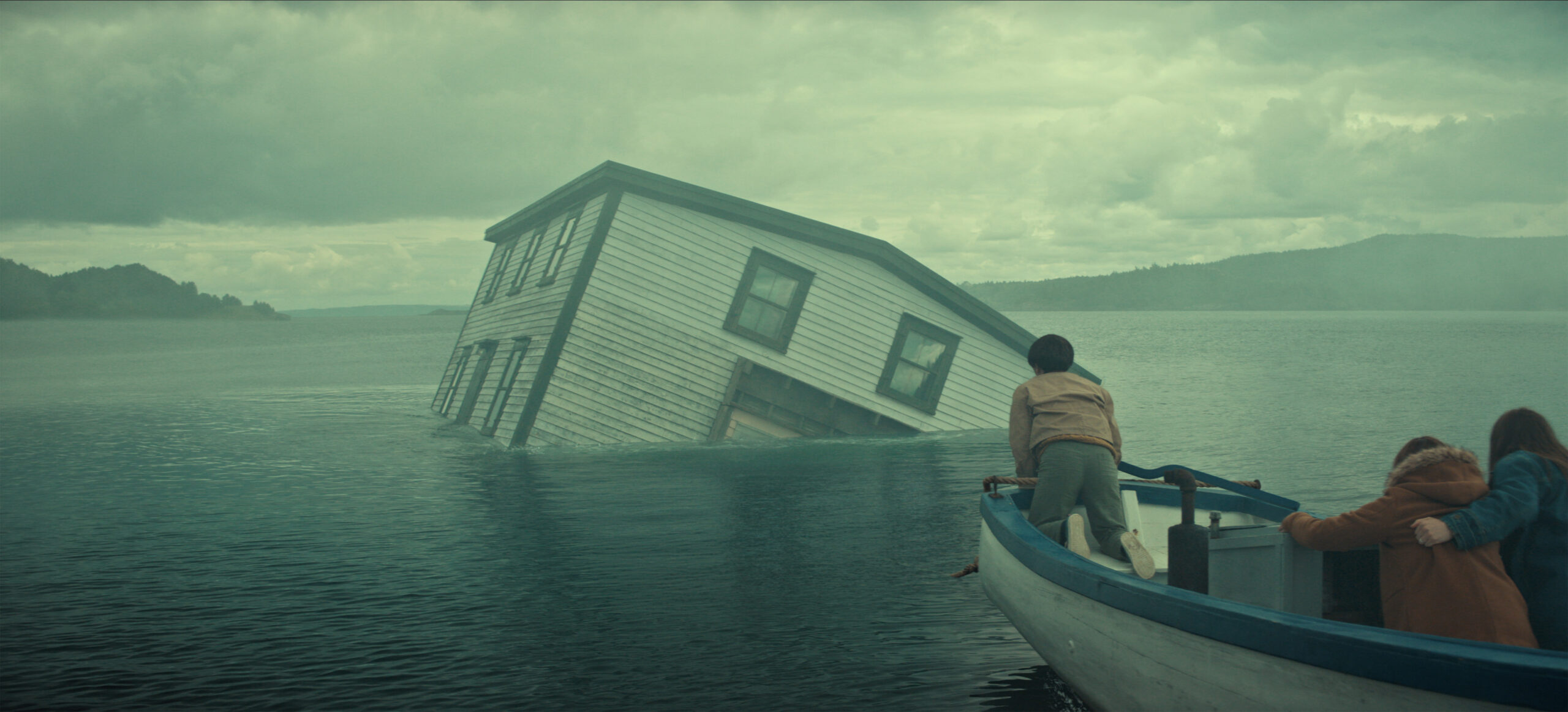 &Quot;A Partially Submerged House Tilts In A Misty Lake As Three People In A Small Boat Observe, With Cloudy Skies And Distant Hills Creating A Dramatic, Mysterious Atmosphere.&Quot;