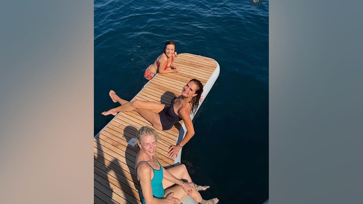 Brooke Shields relaxes on a boat's swim platform alongside Chelsea Handler and a friend during a trip to Croatia.