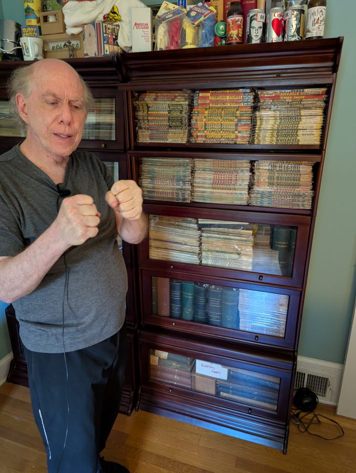 Warren Bernard with his extensive pulp magazine collection