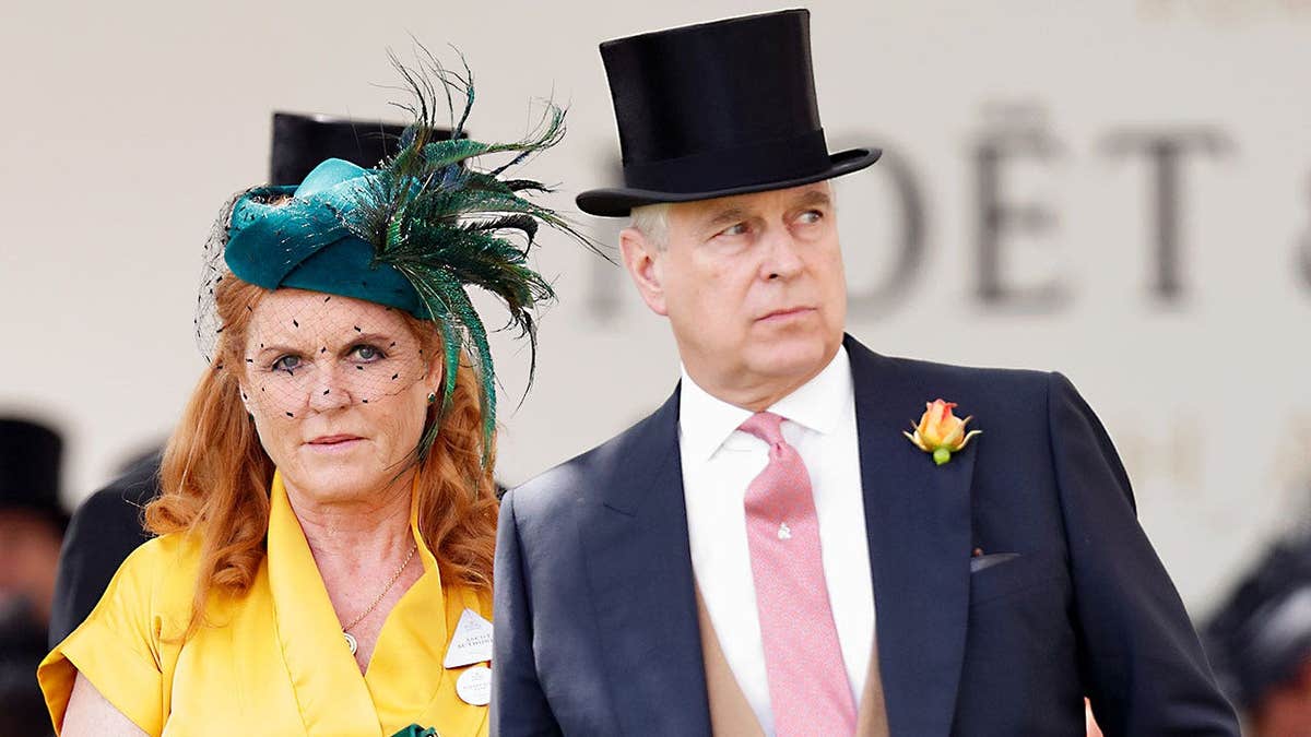 Sarah Ferguson in a yellow hat and fascinator walking alongside Andrew Mountbatten-Windsor in a formal suit and top hat.