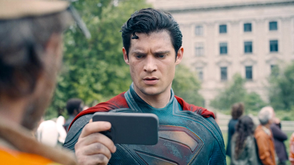Superman (David Corenswet) looking at a phone