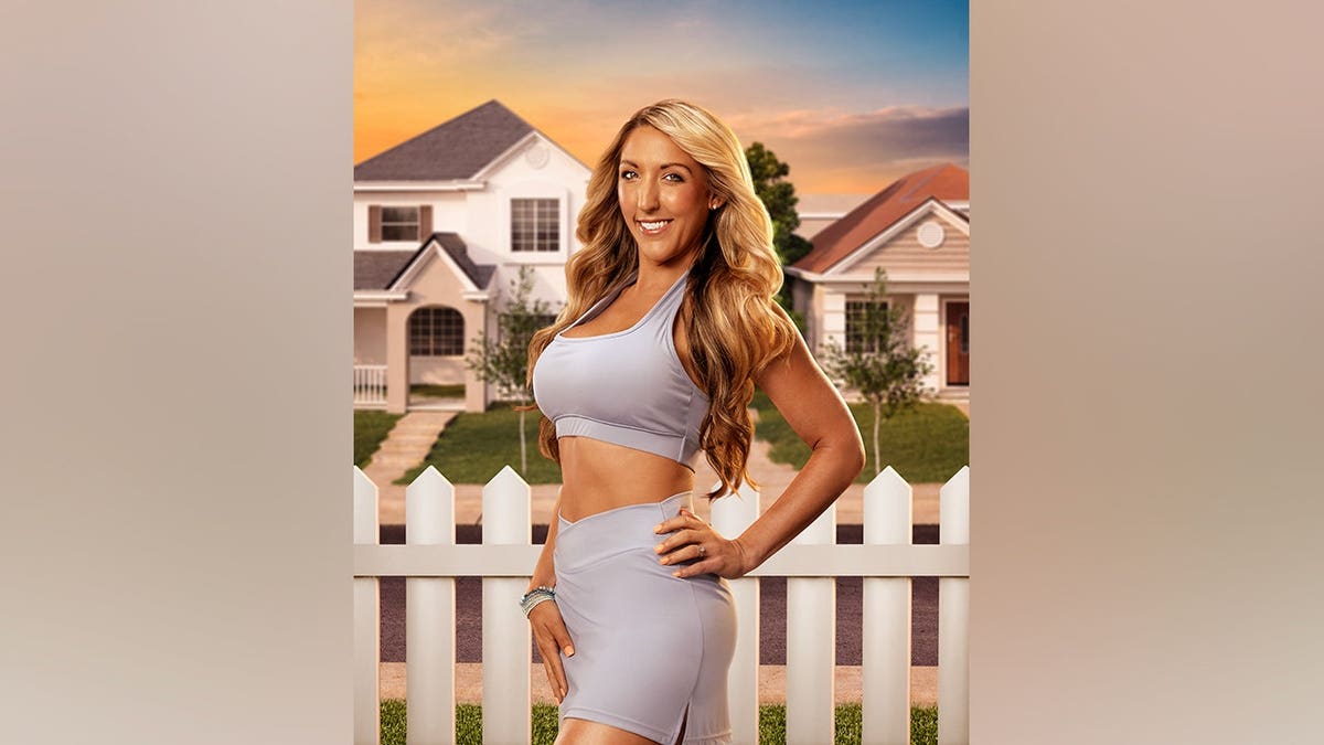 Tammy poses for a solo shot during a cast interview for 'Double Lives of Suburban Wives'.