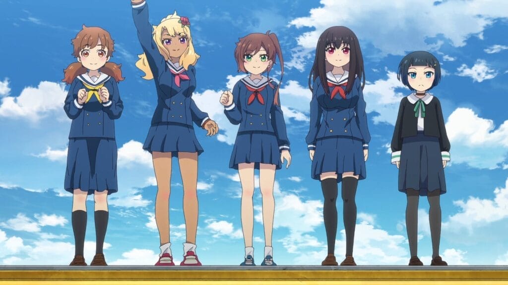 The main cast of Train to the End of the World, including Yoka, standing together on the roof of the yellow train carriage