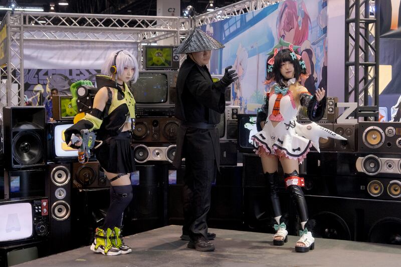 Person taking photo with cosplayers