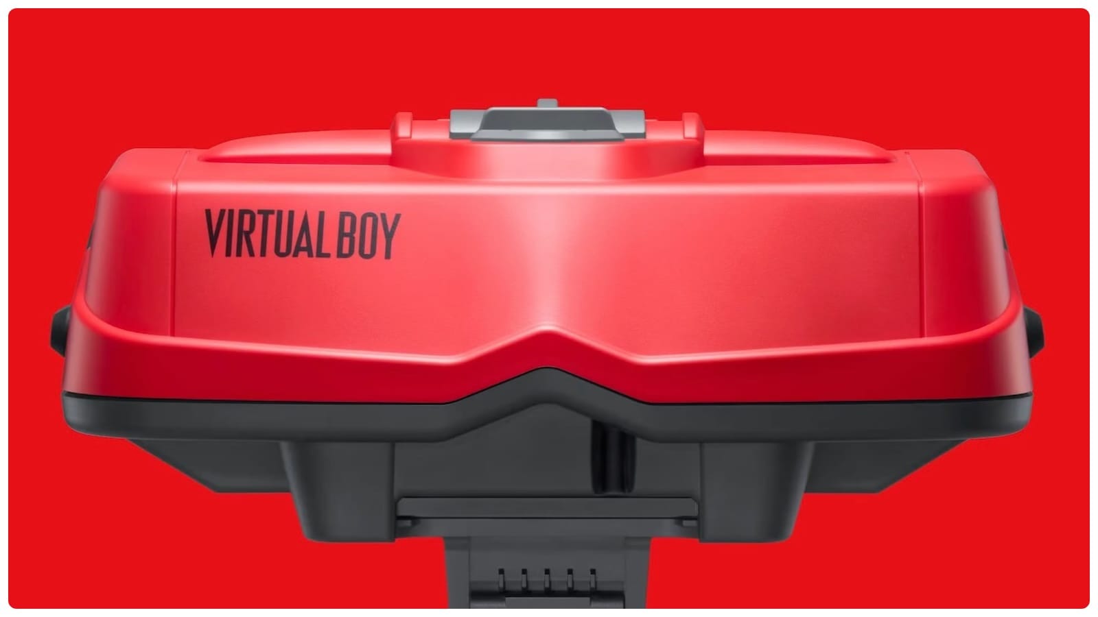 A red Nintendo Virtual Boy headset unit photographed head-on against a red background.