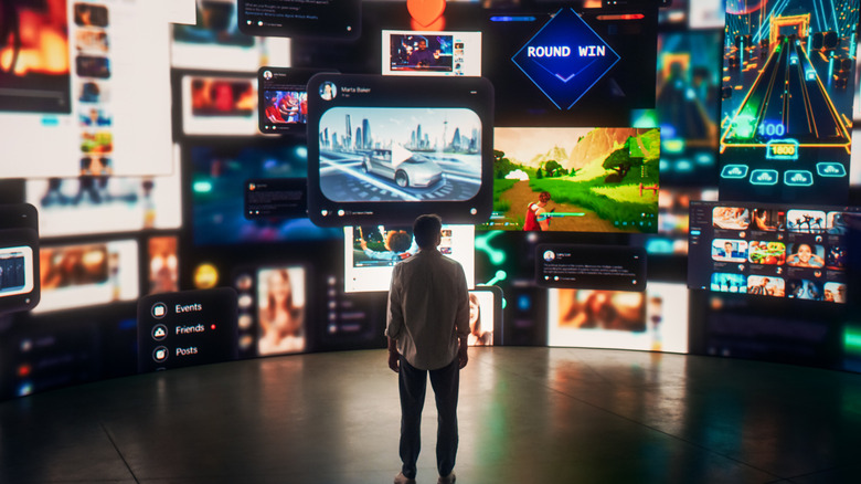 Person looking at wall of TV screens