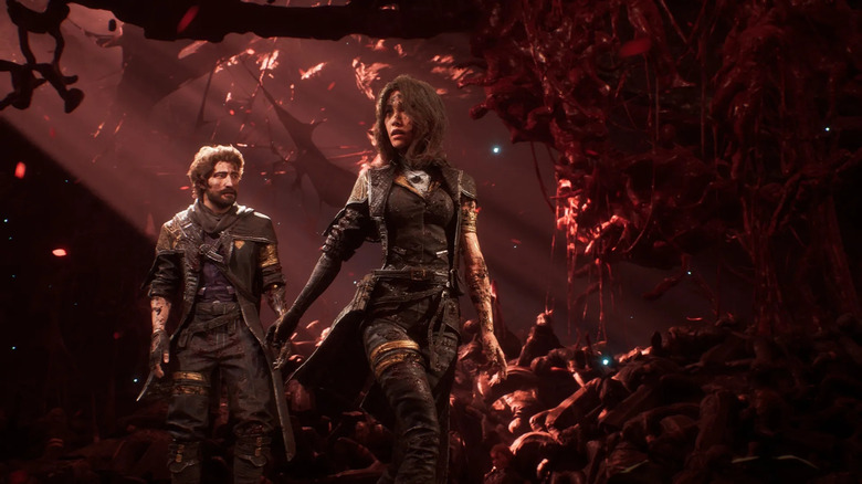Gustave and Maelle walk through a crimson realm in Clair Obscur: Expedition 33