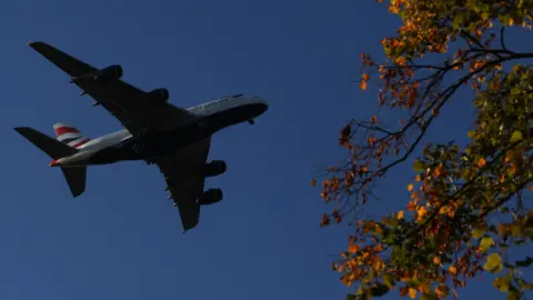 REUTERS/Toby Melville A passenger plane makes its landing approach to Heathrow Airport.
