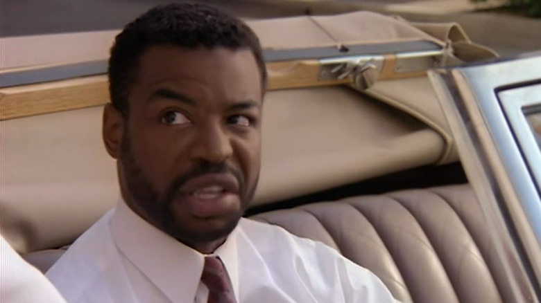 The Boss looking irritated in a car in Deadly Games
