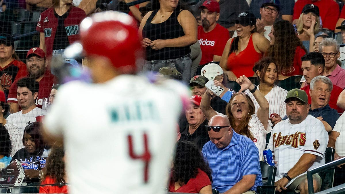 A fan gives thumbs down toward Ketel Marte at Chase Field.