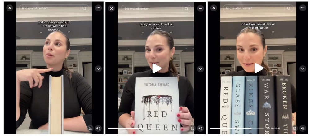 Victoria Aveyard sits at a desk and shows her book series to the camera in a TikTok video..