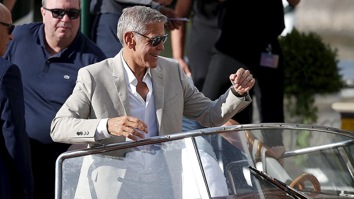George Clooney stands at the Hotel Excelsior Venice Lido pier.