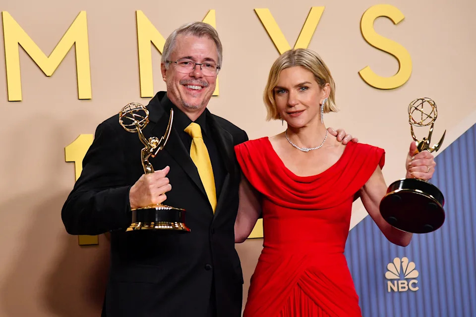 Pluribus creator Vince Gilligan and star Rhea Seehorn holding their Emmys.