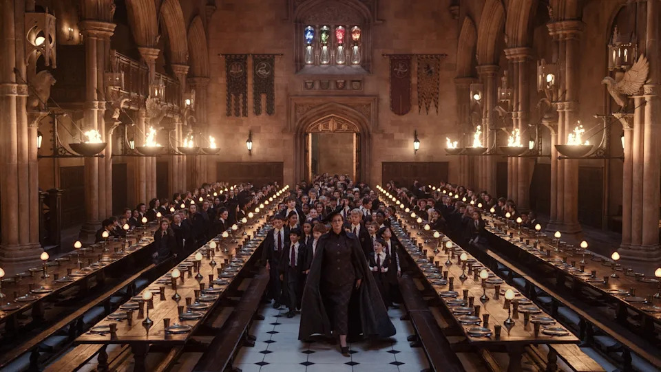 Janet McTeer leads Hogwarts students through the Great Hall in Harry Potter and the Philosopher's Stone.