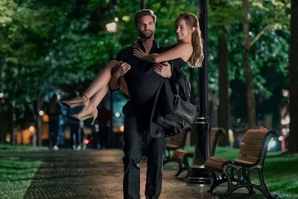 Tom Bateman carries Lili Reinhart through the park