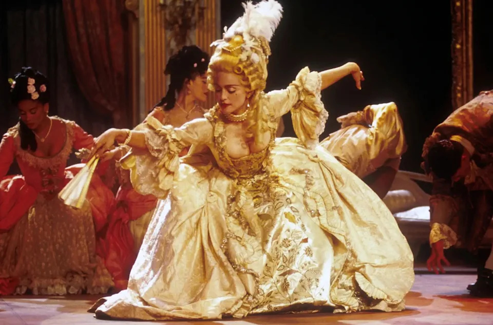 Madonna performs "Vogue" in an elaborate 18th-century-inspired gown with a voluminous skirt and ornate powdered hairstyle.