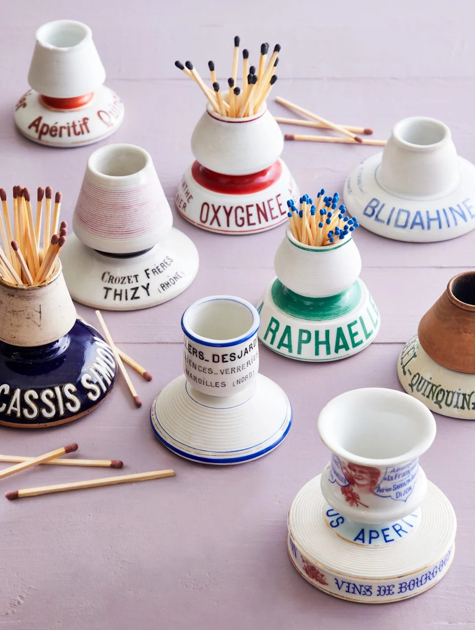 vintage ceramic match holders in various shapes and designs containing matches