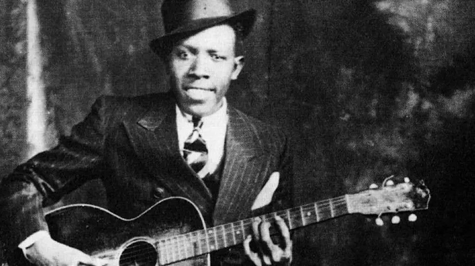 Robert Johnson holding a guitar