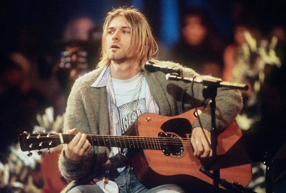 Kurt Cobain on stage with guitar