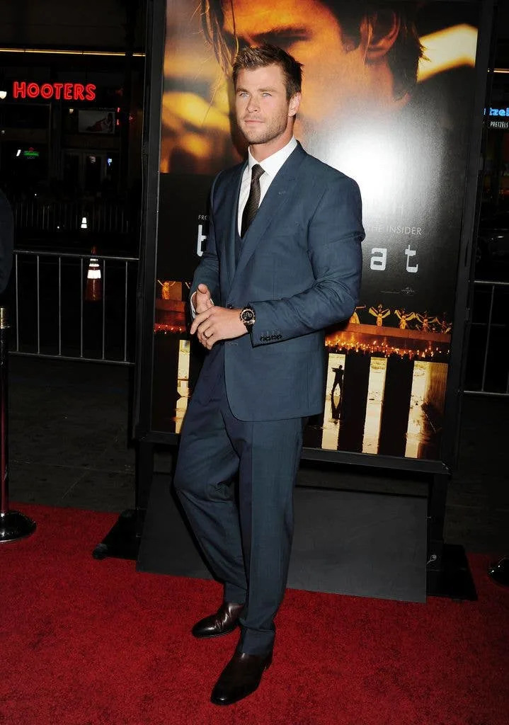 Chris Hemsworth pictured on the red carpet in front of a banner poster for 'Blackhat' in 2015.