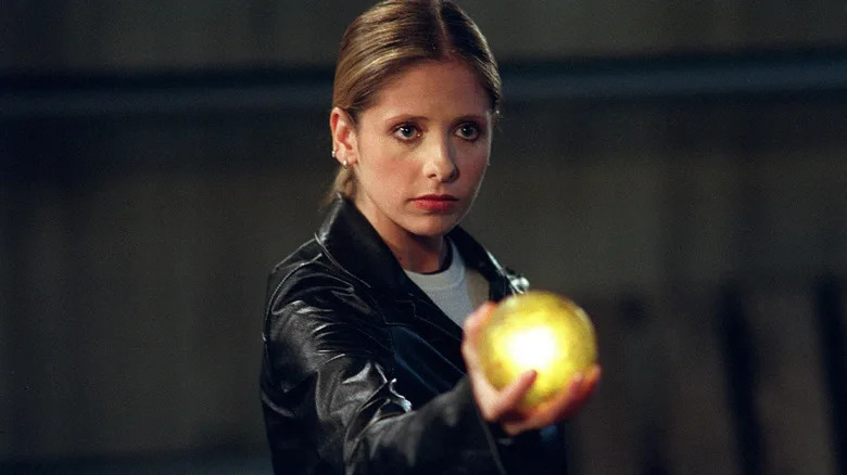 Buffy holds up a yellow glowing orb on "Buffy the Vampire Slayer" (1997-2003)