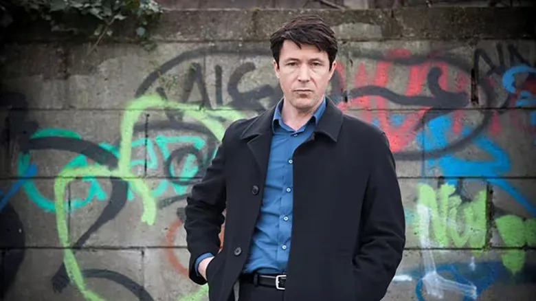 John Boy in front of graffiti in Love/Hate
