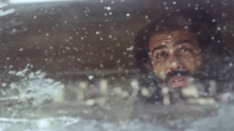Andre Layton looking out of a snowy window in Snowpiercer