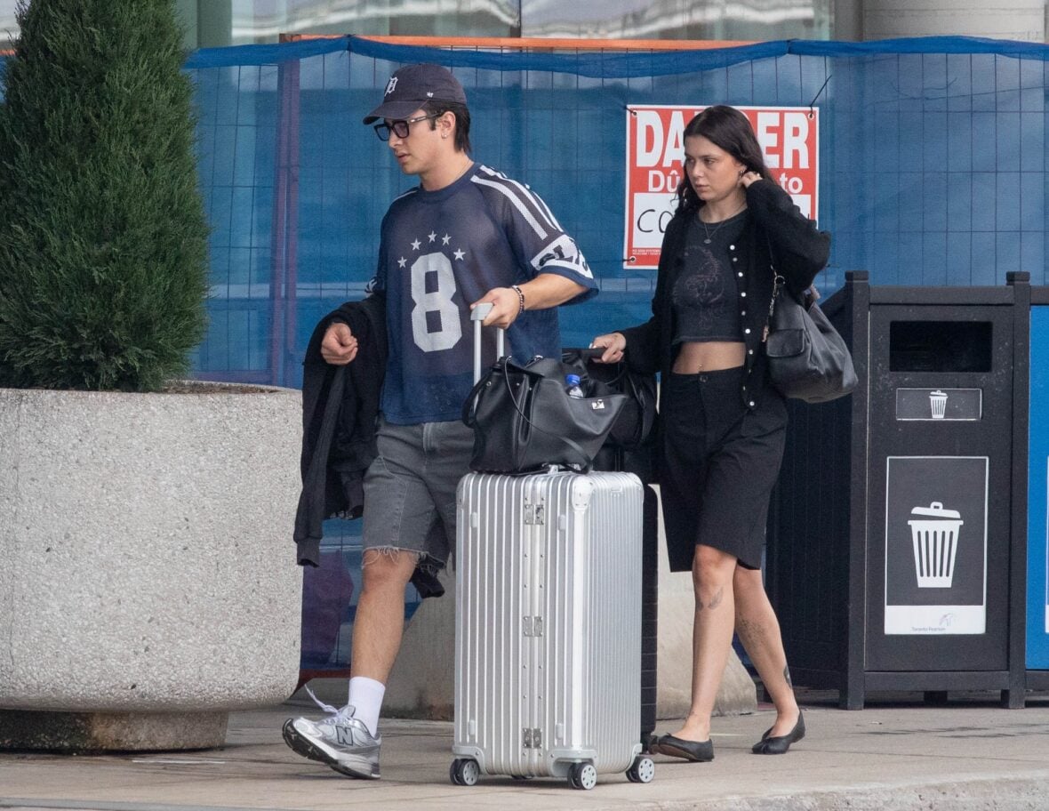 Hudson Williams and Katelyn Larson walking together in Toronto Airport