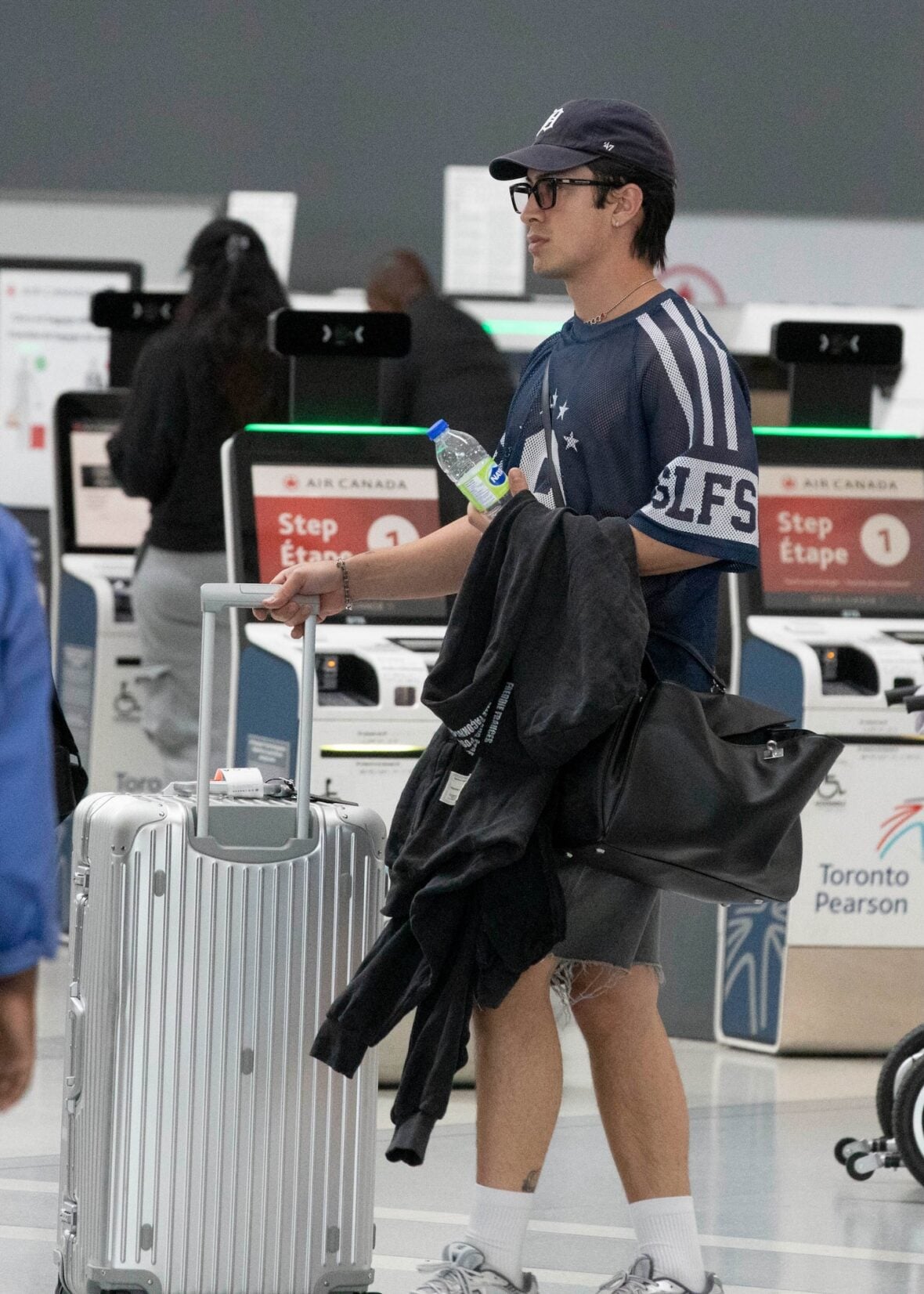 Hudson Williams and Katelyn Larson walking together in Toronto Airport