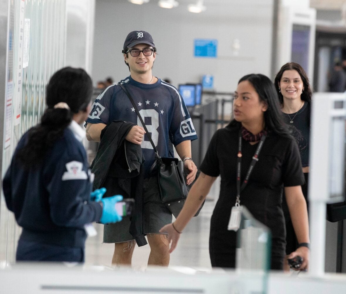 Hudson Williams and Katelyn Larson walking together in Toronto Airport
