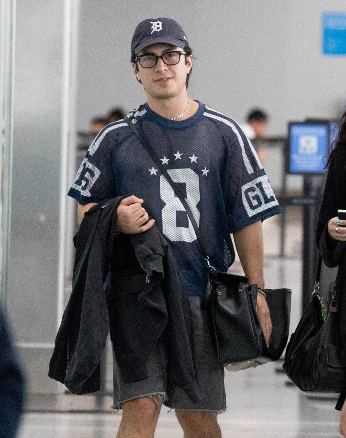 Hudson Williams and Katelyn Larson walking together in Toronto Airport