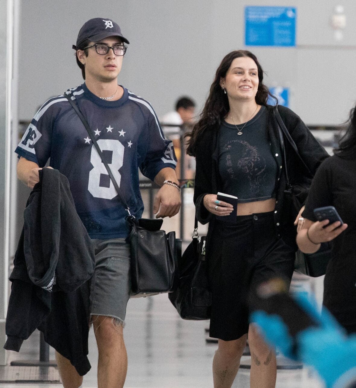 Hudson Williams and Katelyn Larson walking together in Toronto Airport