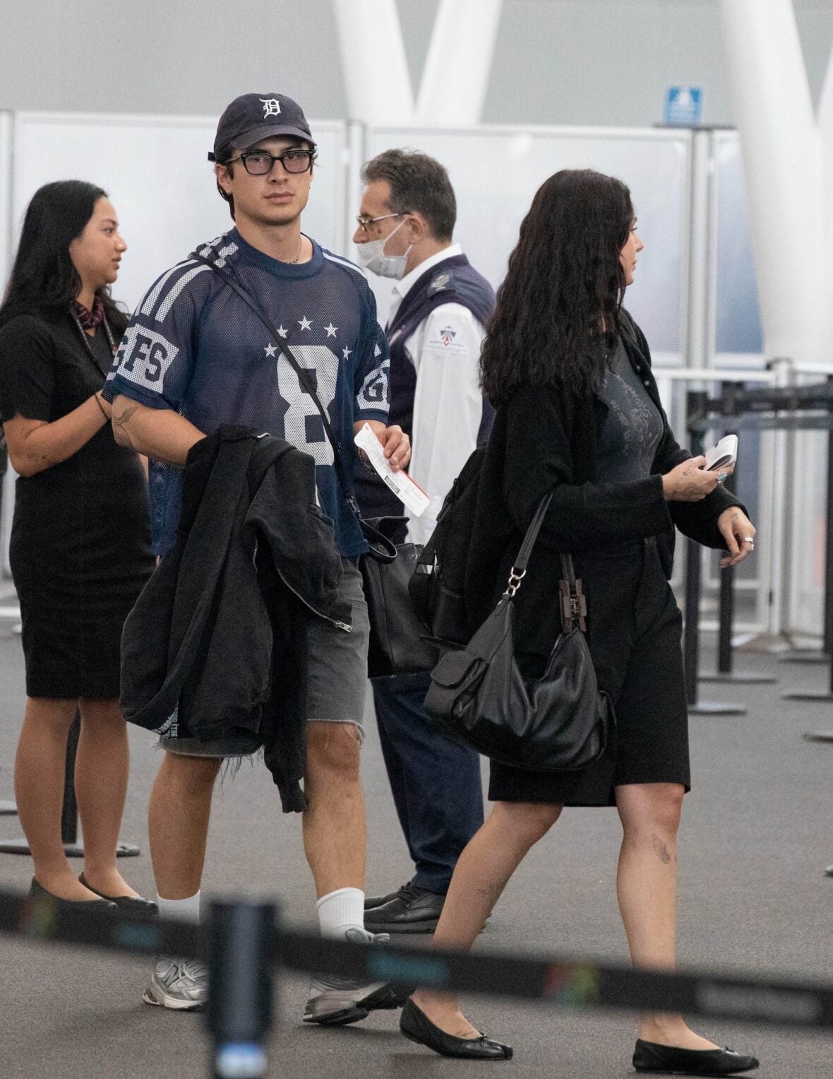 Hudson Williams and Katelyn Larson walking together in Toronto Airport