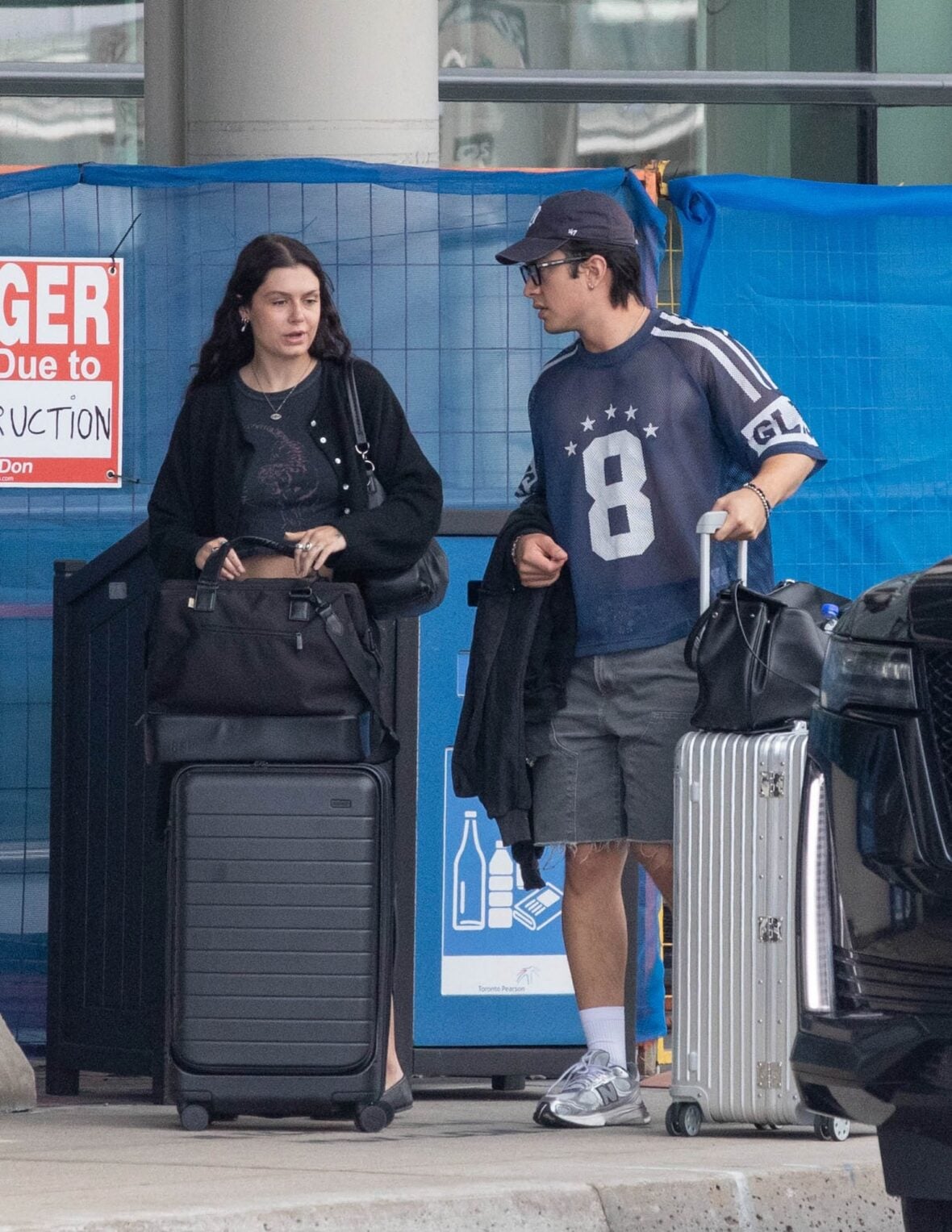 Hudson Williams and Katelyn Larson walking together in Toronto Airport