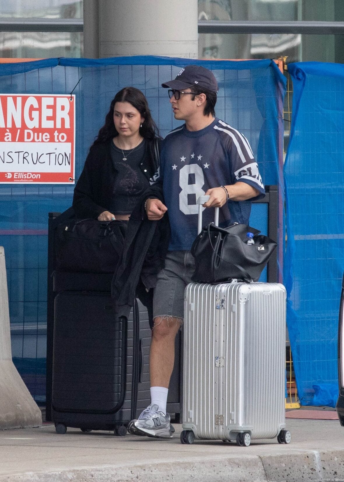 Hudson Williams and Katelyn Larson walking together in Toronto Airport