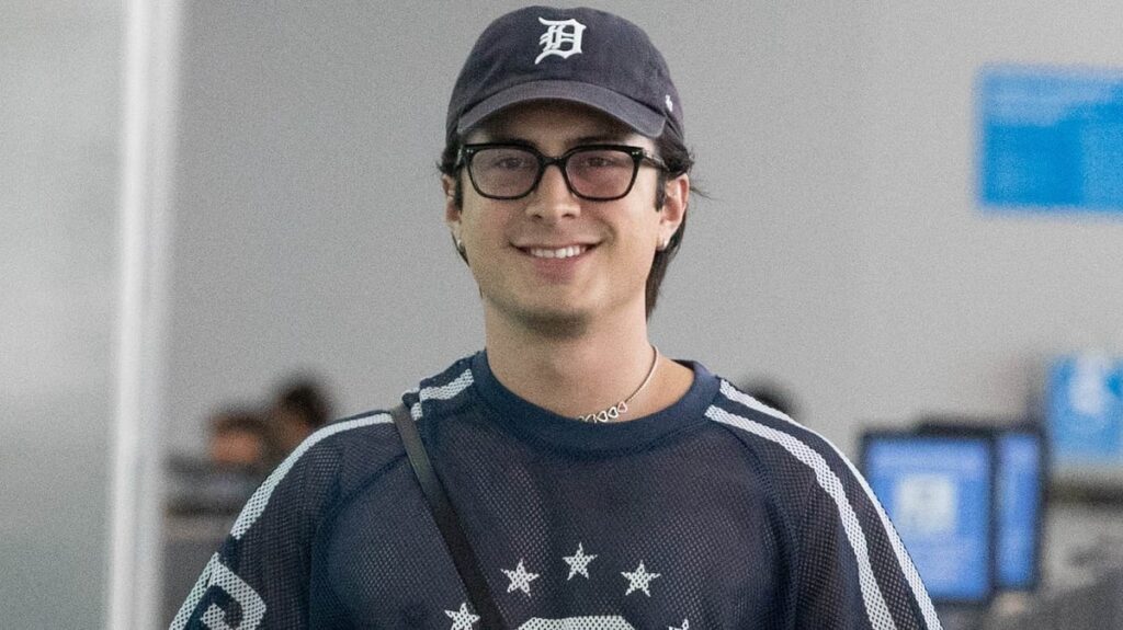 Hudson Williams Wears Sheer Jersey While Flying Out of Toronto With Girlfriend Katelyn Larson
