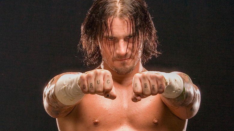 CM Punk showing off his "DRUG FREE" finger tattoos during a WWE photoshoot.