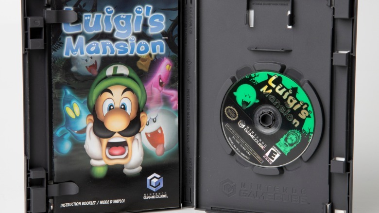 Shot of open copy of Luigi's Mansion with instruction book and disk in case.