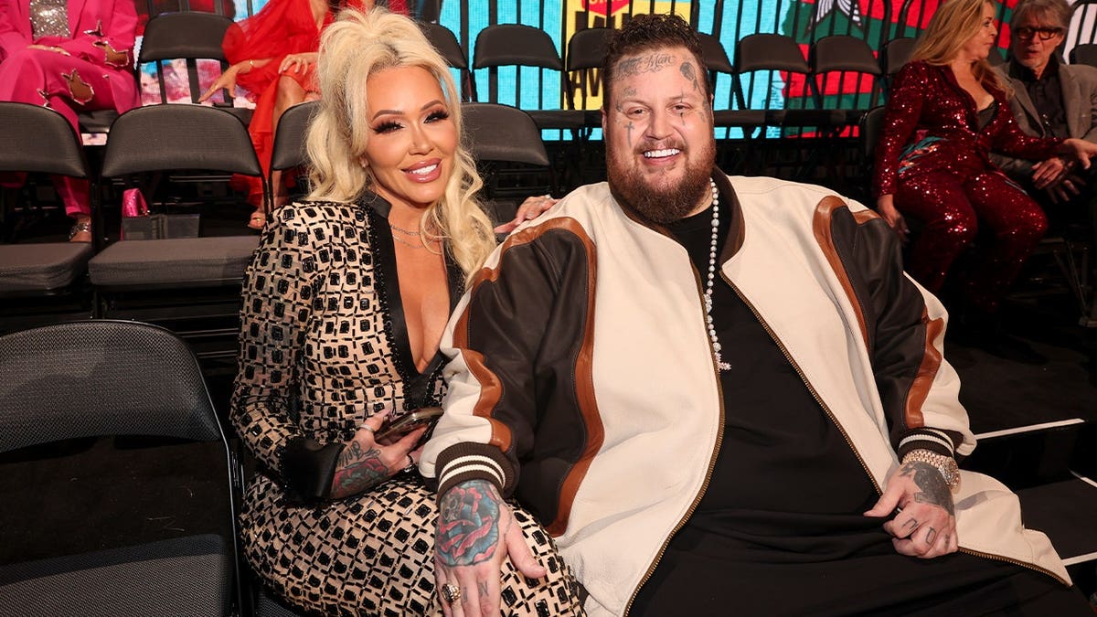 Bunnie XO and Jelly Roll sit on chairs