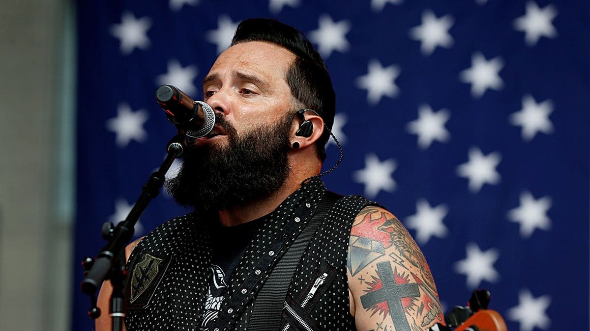 John Cooper of Skillet performs on stage outdoors in New York City.
