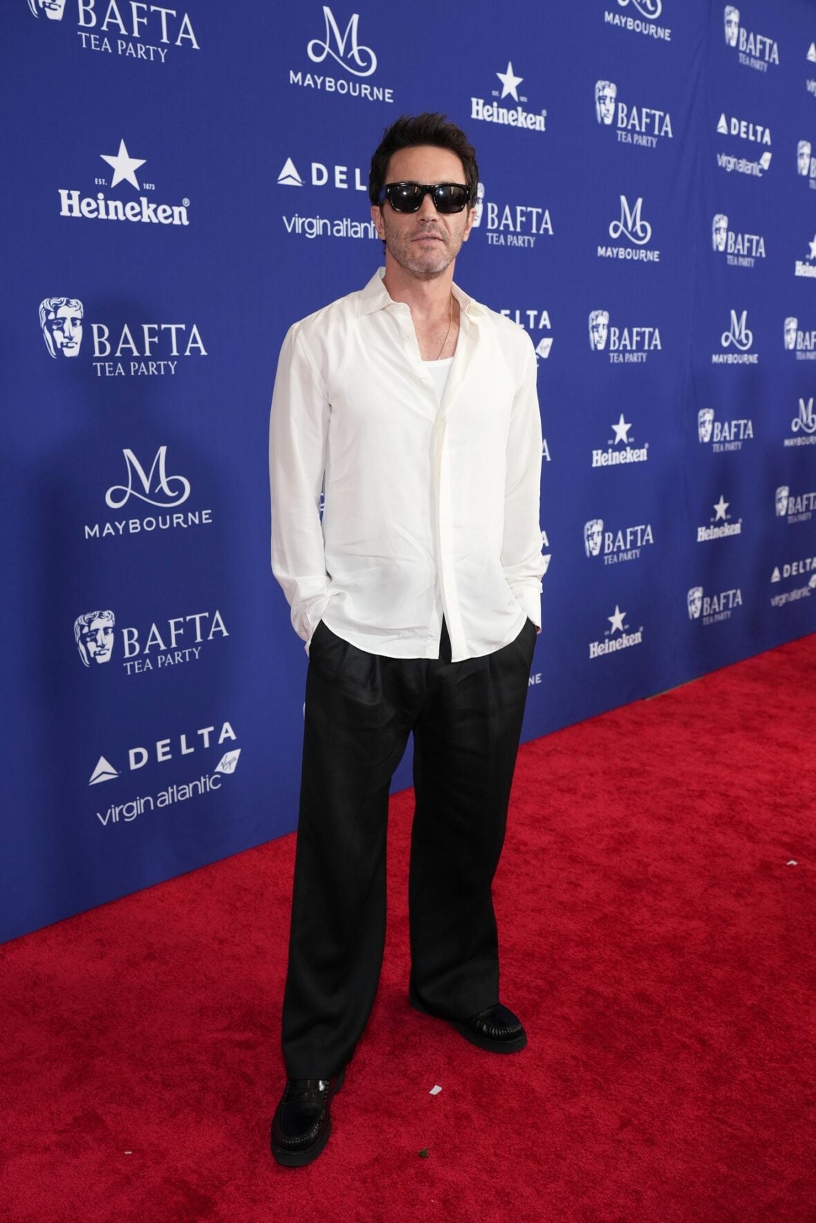 Tom Pelphrey poses on the red carpet at the BAFTA TV Tea Party