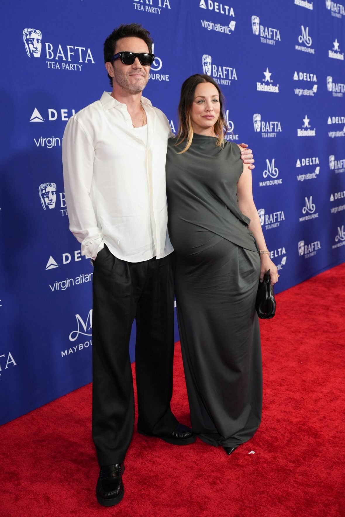 Kaley Cuoco and Tom Pelphrey pose on the red carpet at the BAFTA TV Tea Party